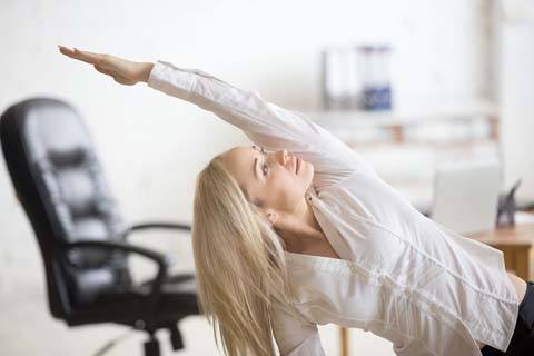 lady at Levittown business doing stretches to stay fit